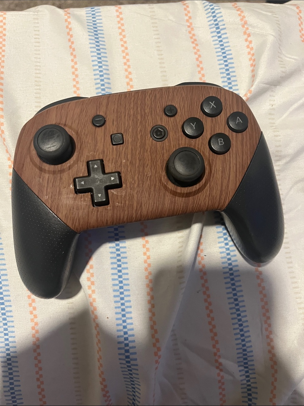Nintendo Switch Pro Controller featuring a customized wood-grain